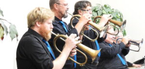 Five musicians playing horns